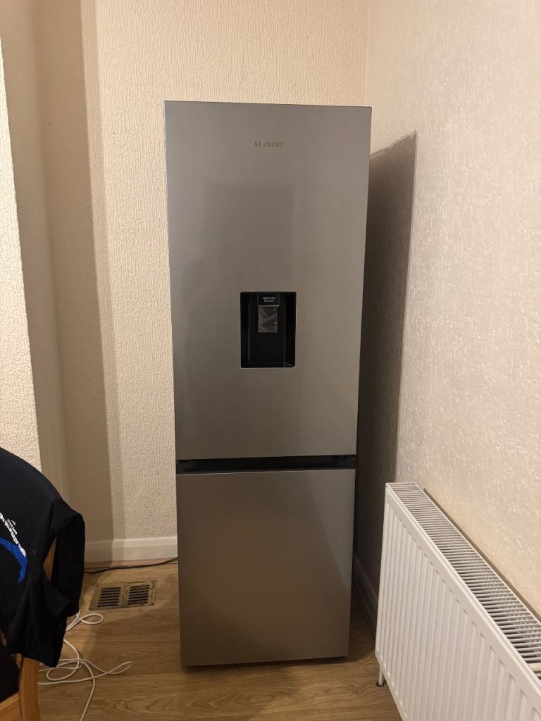 Silver Samsung refrigerator with front water dispenser