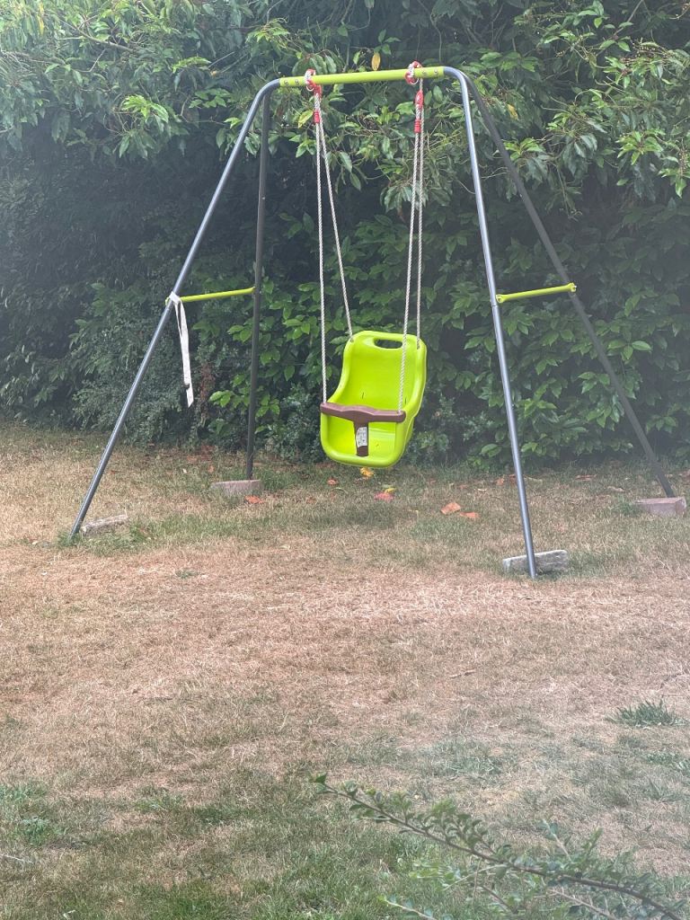 Green Plastic Swing Seat with Black Ropes and Yellow Connectors