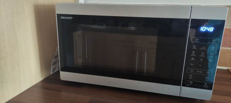 Sharp microwave oven with silver exterior and digital display
